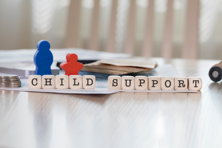 Word CHILD SUPPORT composed of wooden letters.